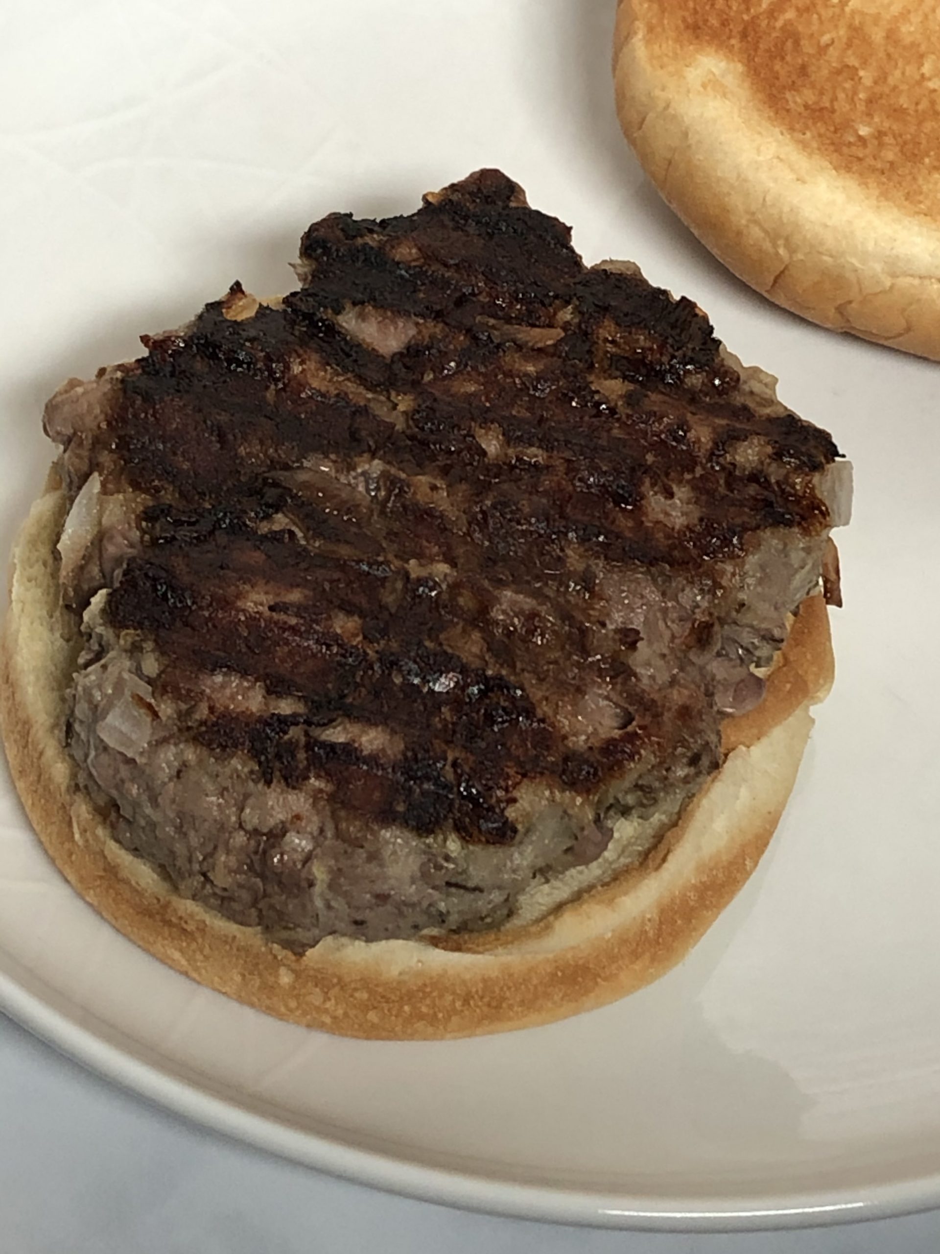 Lamb burger on the bottom half of a bun