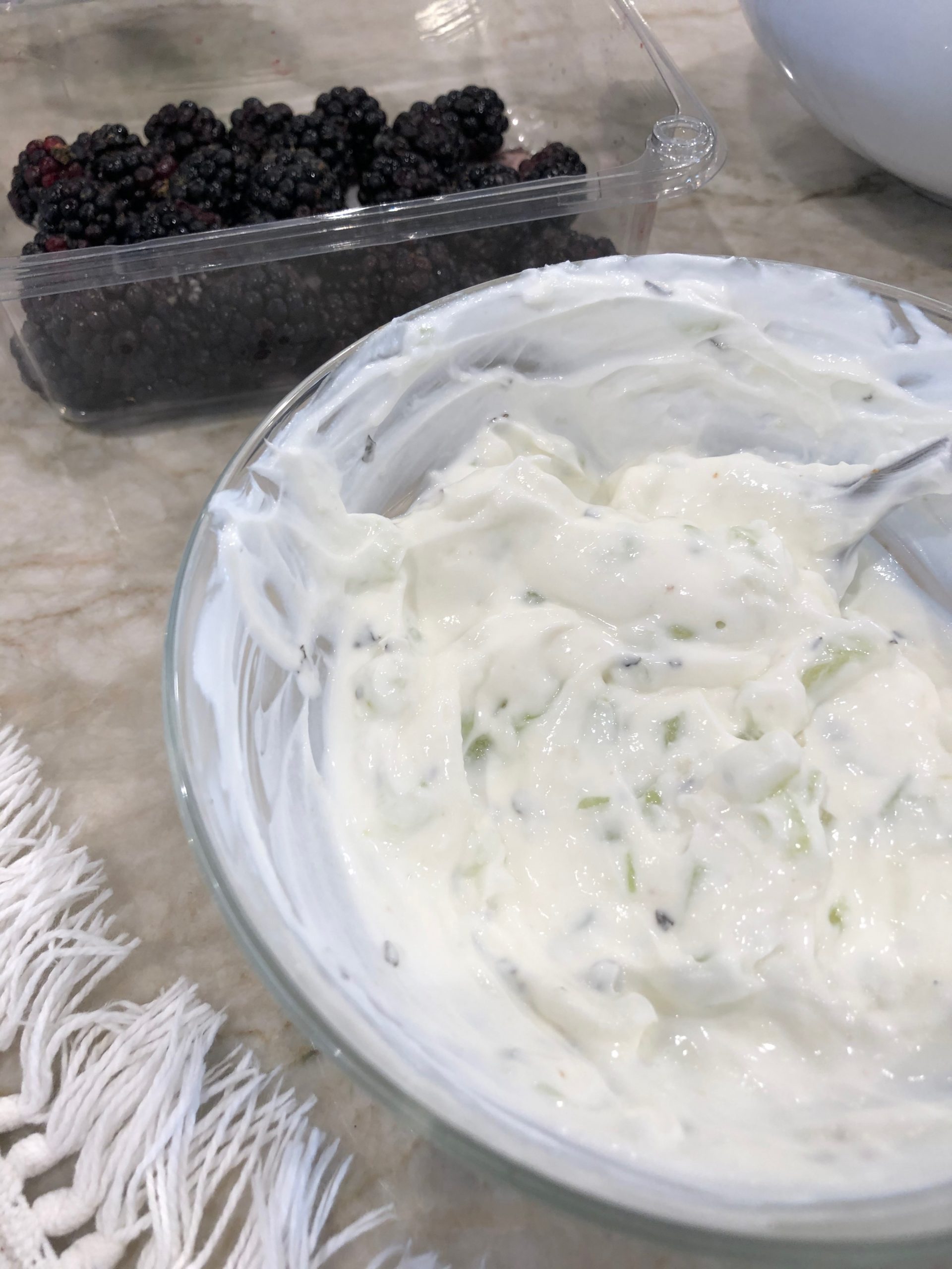 Tzatziki Sauce in a bowl with blackberries next to it