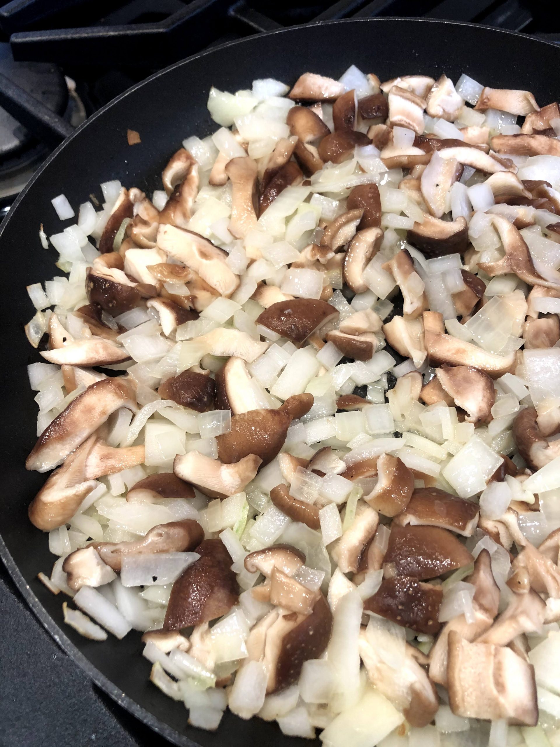 mushrooms and onions in a saute pan