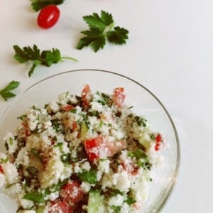 a glass bowl filled with cauliflower tabbouleh