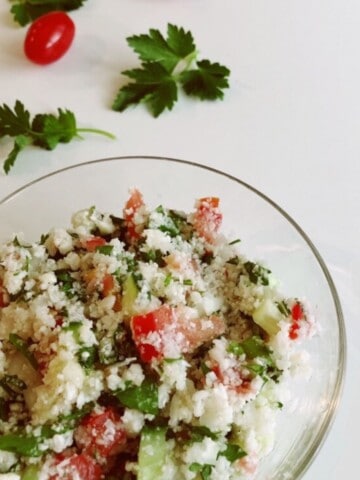 a glass bowl filled with cauliflower tabbouleh