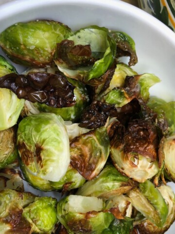Roasted Brussel Sprouts in a white bowl.