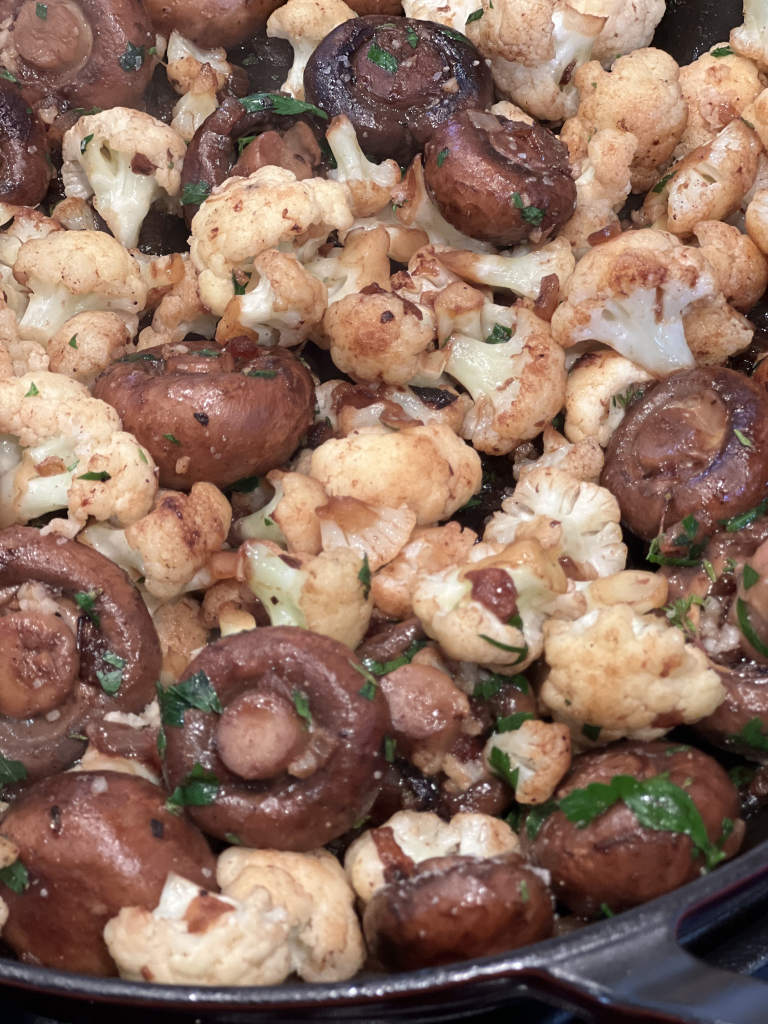 mushrooms and cauliflower in a skillet