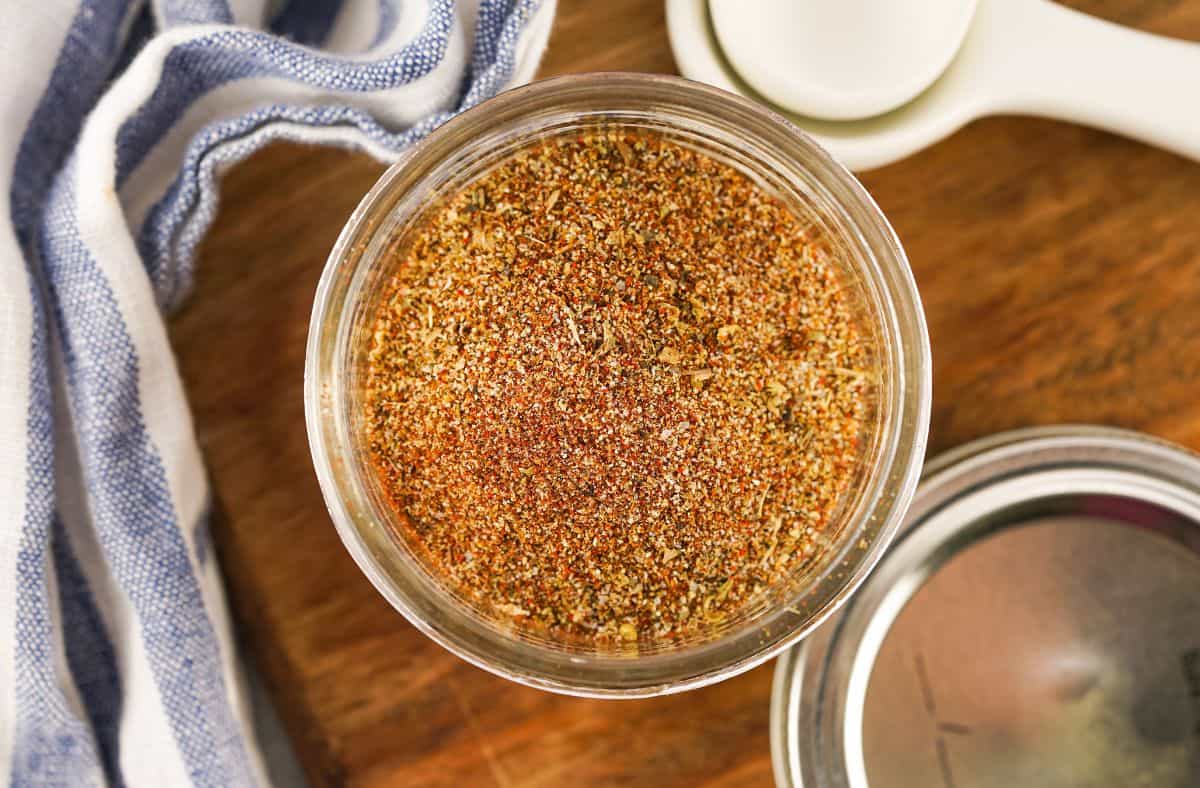 Authentic Homemade Taco Seasoning Recipe in a mason jar with a blue and white towel