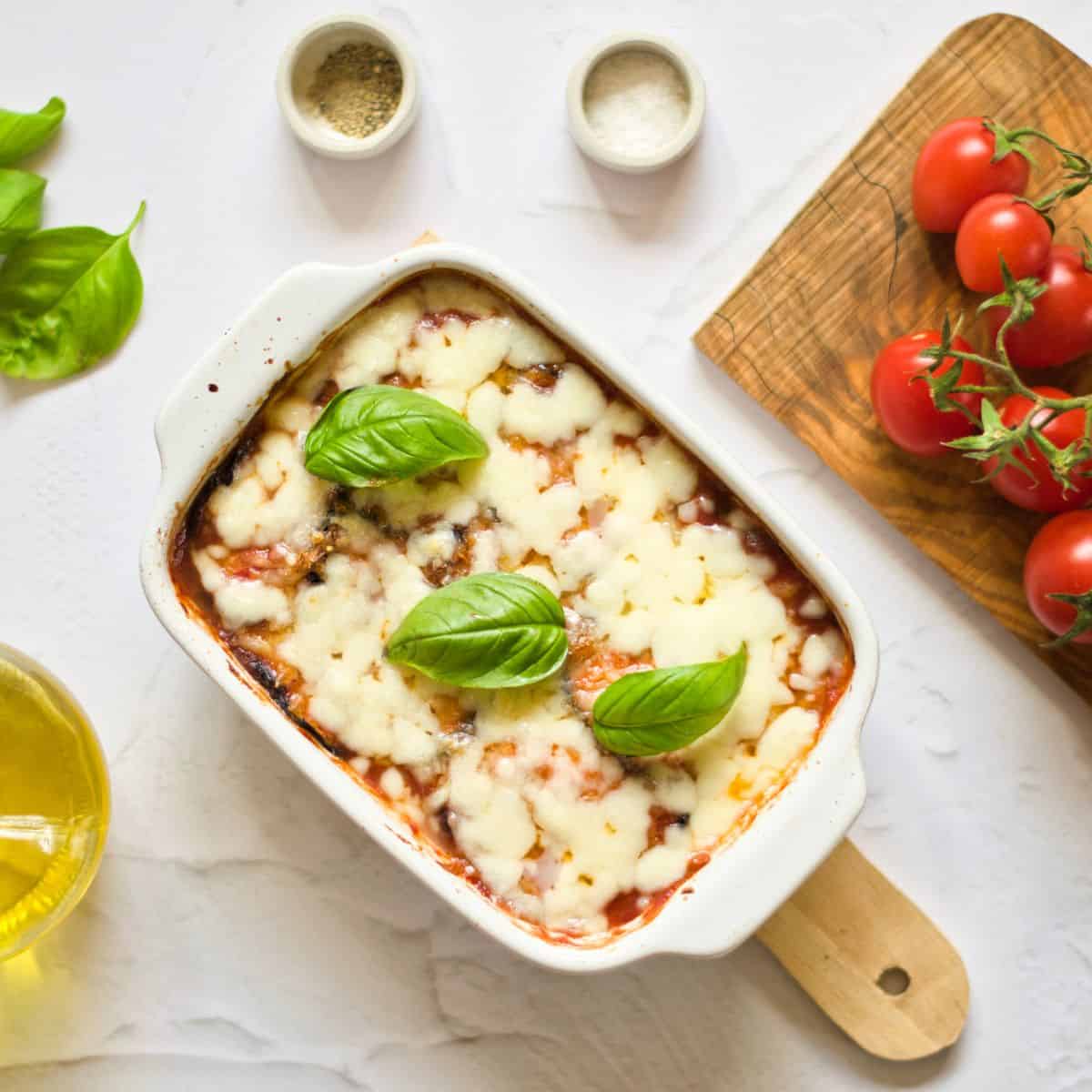 Baked Eggplant Parmesan Without Breadcrumbs Recipe casserole with tomatos on the side