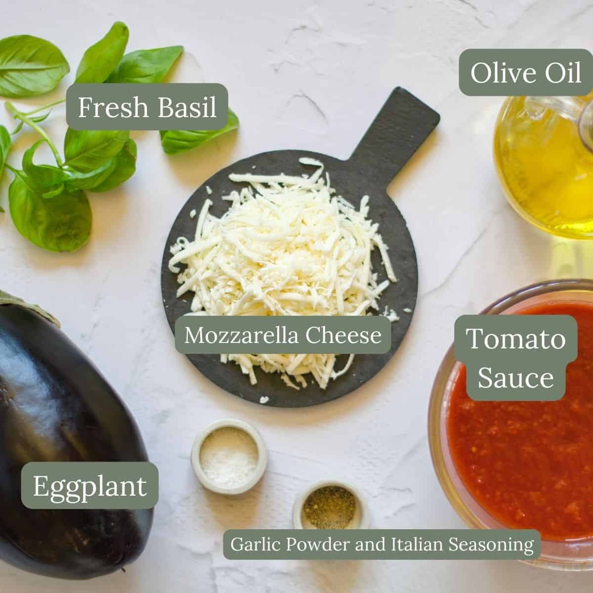 ingredients for Baked Eggplant Parmesan Without Breadcrumbs Recipe which include eggplant, mozzarella cheese, tomato sauce, basil, and olive oil.