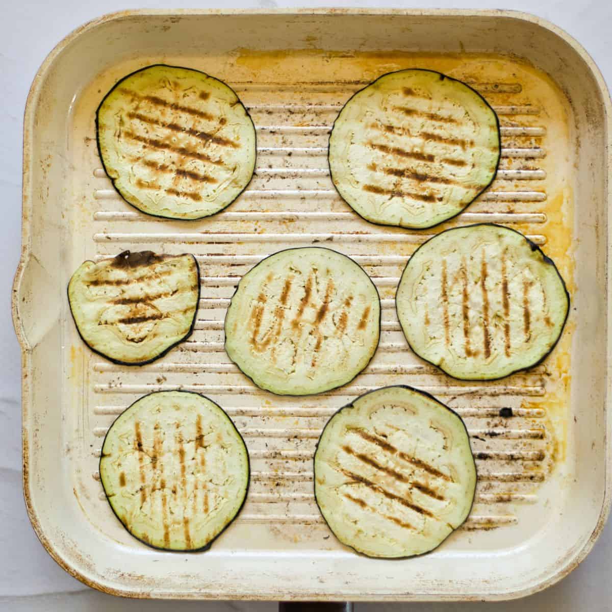 grilling eggplant slices in a grill pan