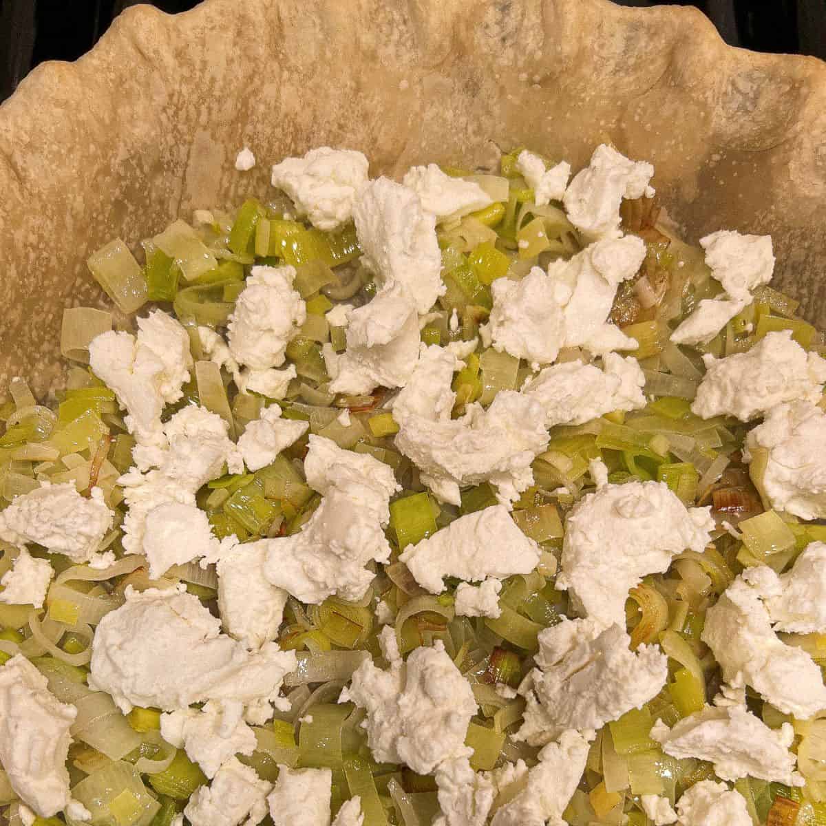 cooked leeks and goat cheese in a pie crust