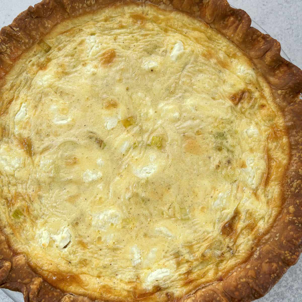 finished leek and goat cheese quiche cooling on a rack