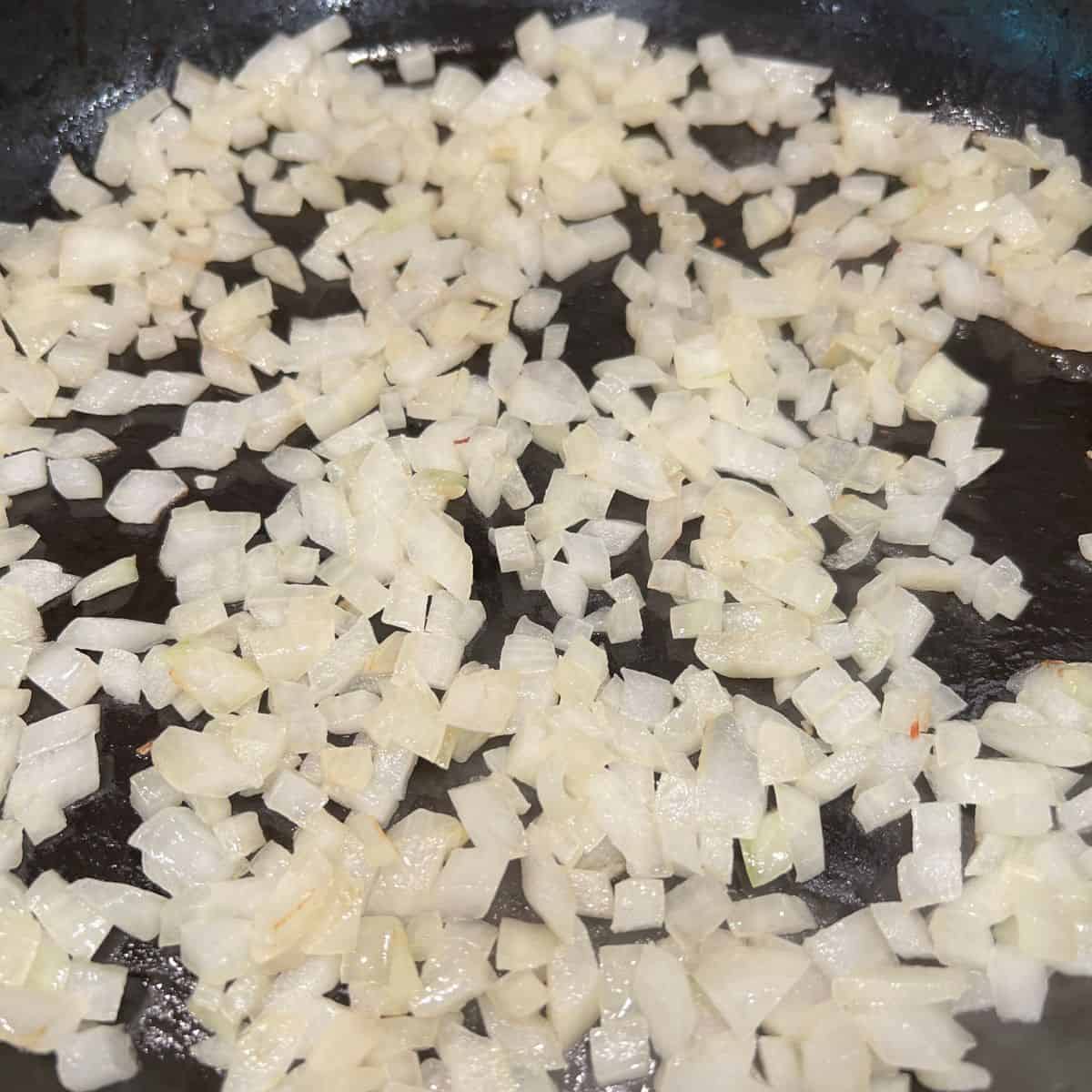 onions sauteing in butter in a pan