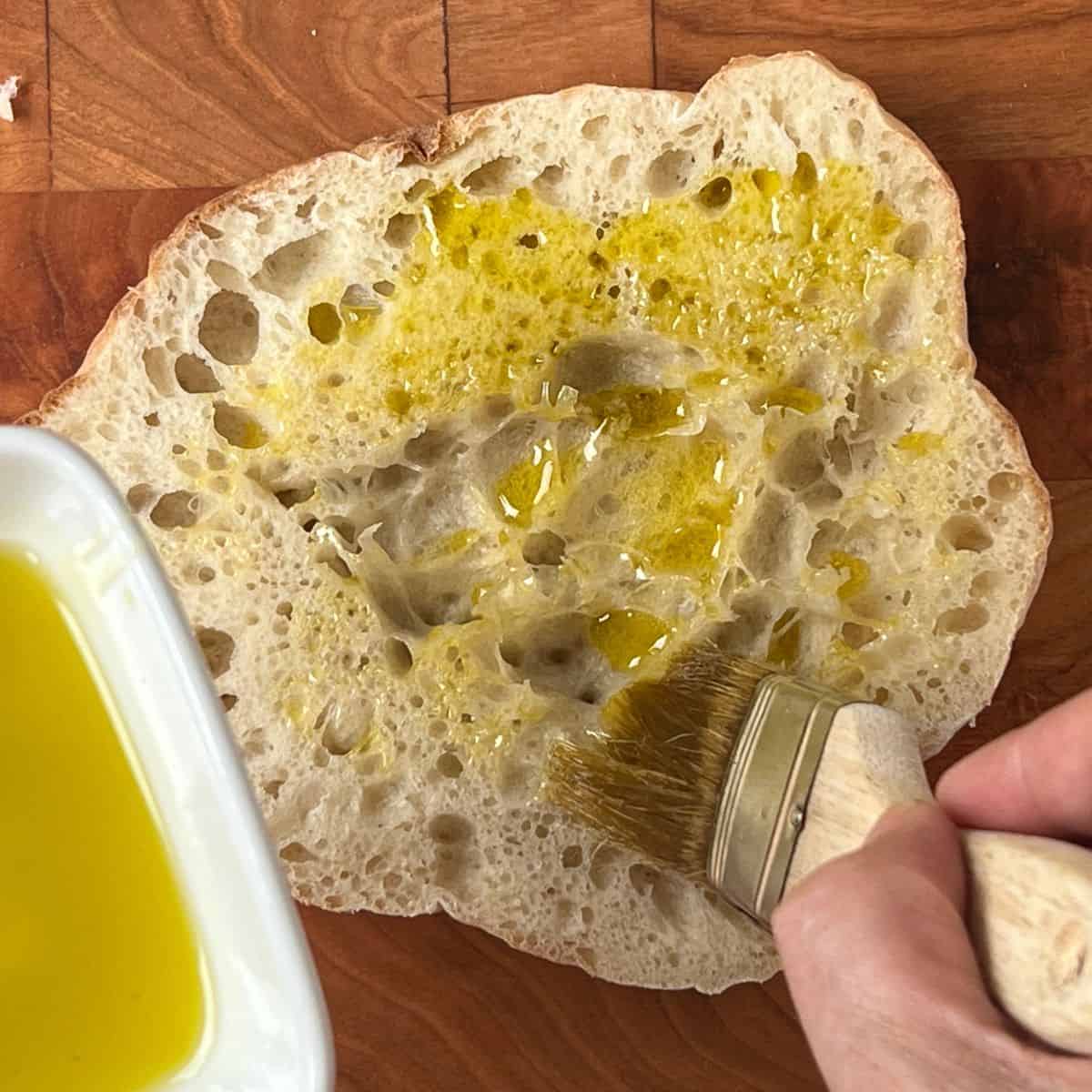 brushing pita bread with olive oil