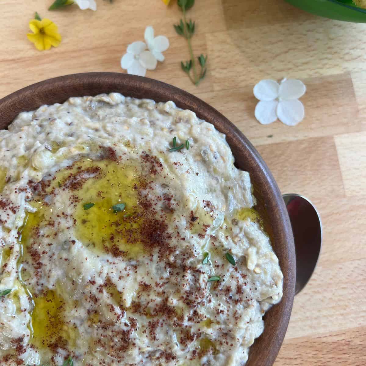 Finished eggplant salad in a bowl with a spoon