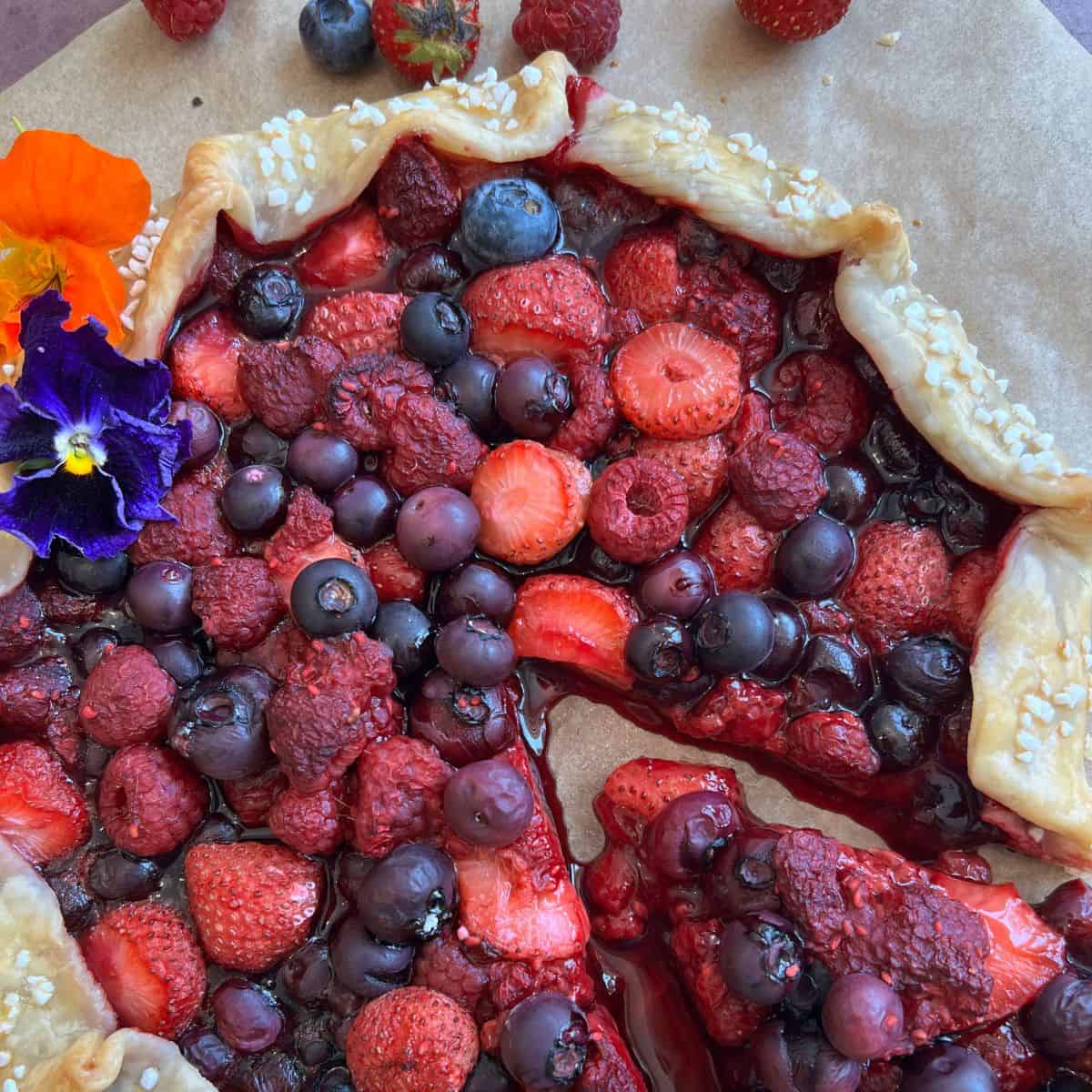 Easy Mixed Berry Galette finished with a slice taken out. 