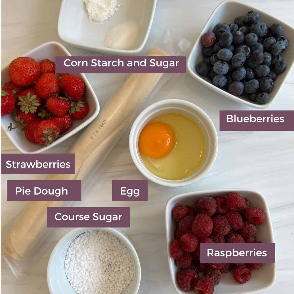 All of the ingredients needed to make a mixed berry galette are corn starch, sugar, berries, egg, pie dough and coarse sugar. 