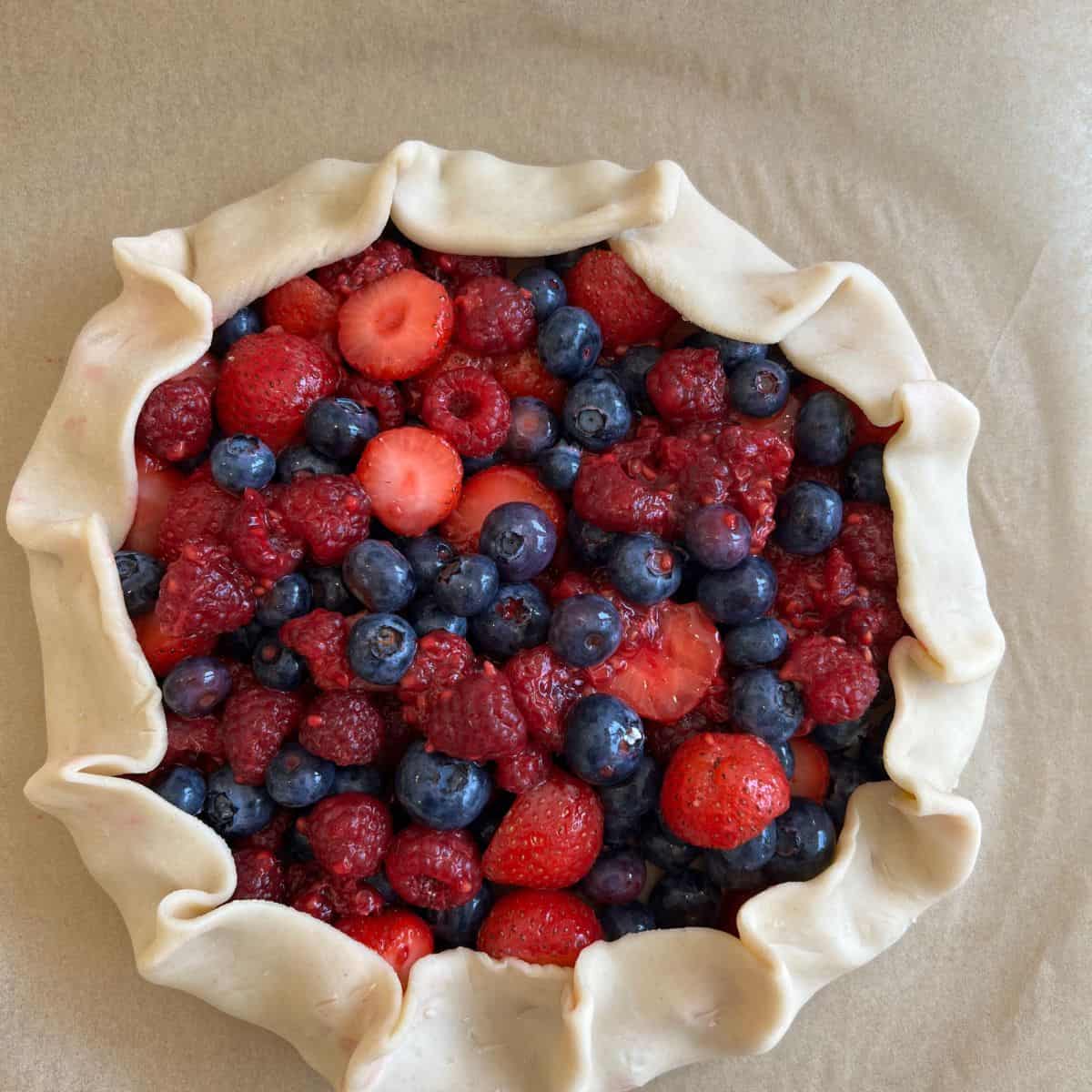uncooked pie dough folded over berries