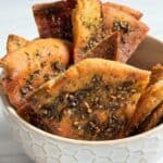 Za'atar pita chips in a white bowl.