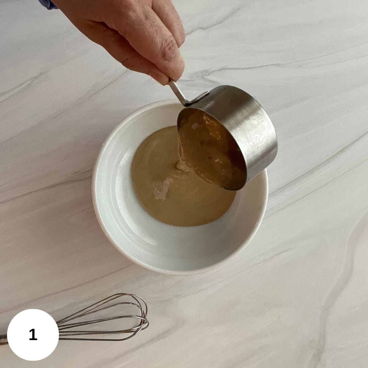 Pouring the tahini sauce into a small bowl. 