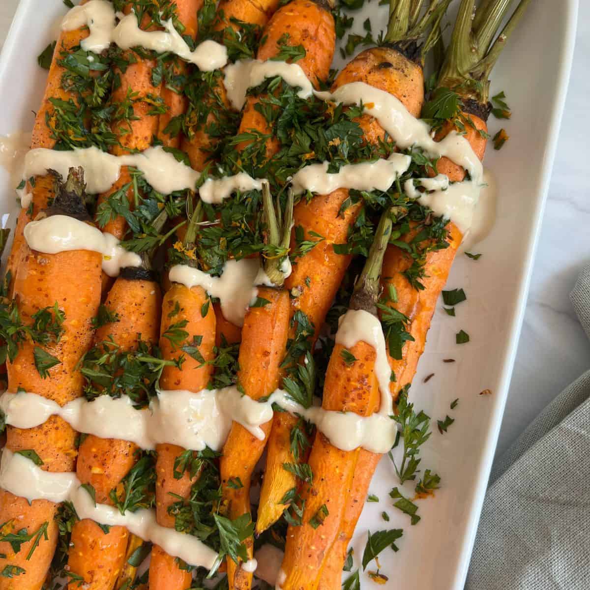 roasted carrots topped with tahini sauce and gremolata.