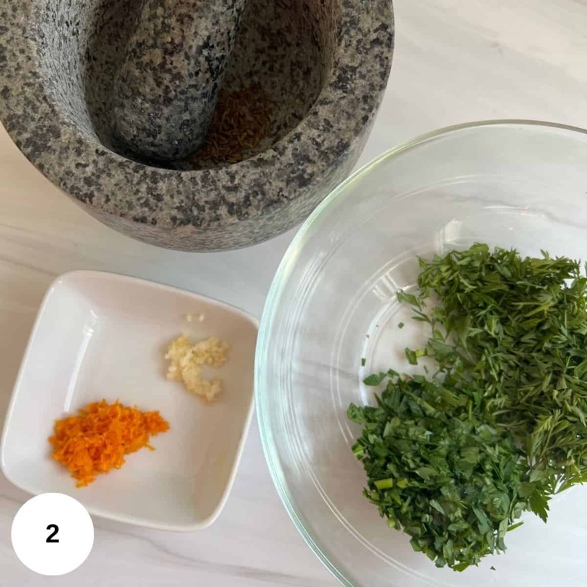 preparing the gremolata with parsley, orange zest, and garlic.