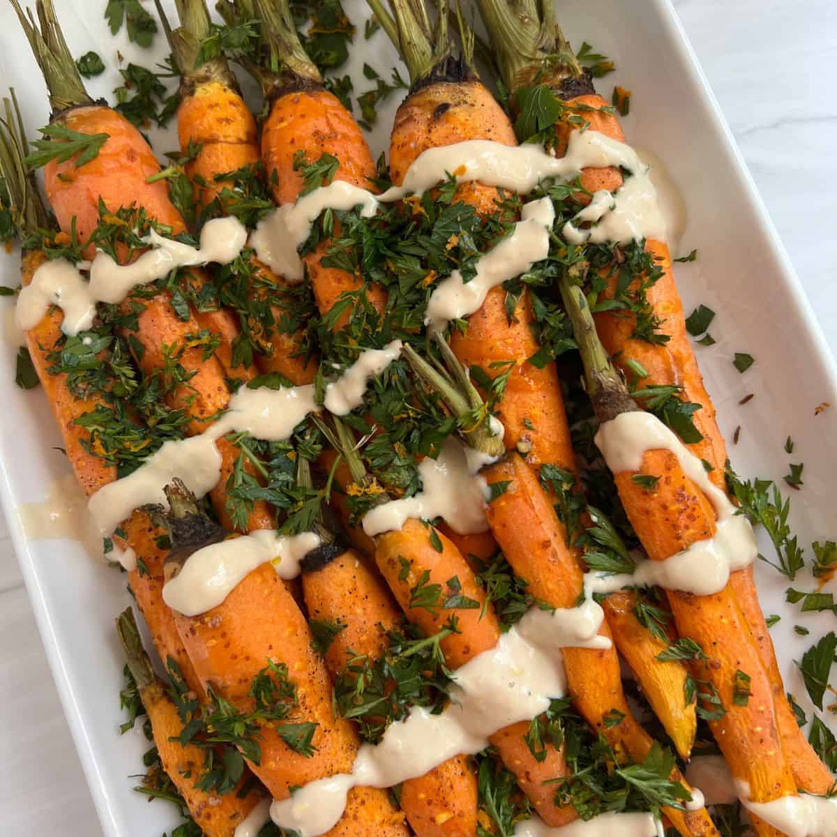 roasted carrots topped with tahini sauce and gremolata.