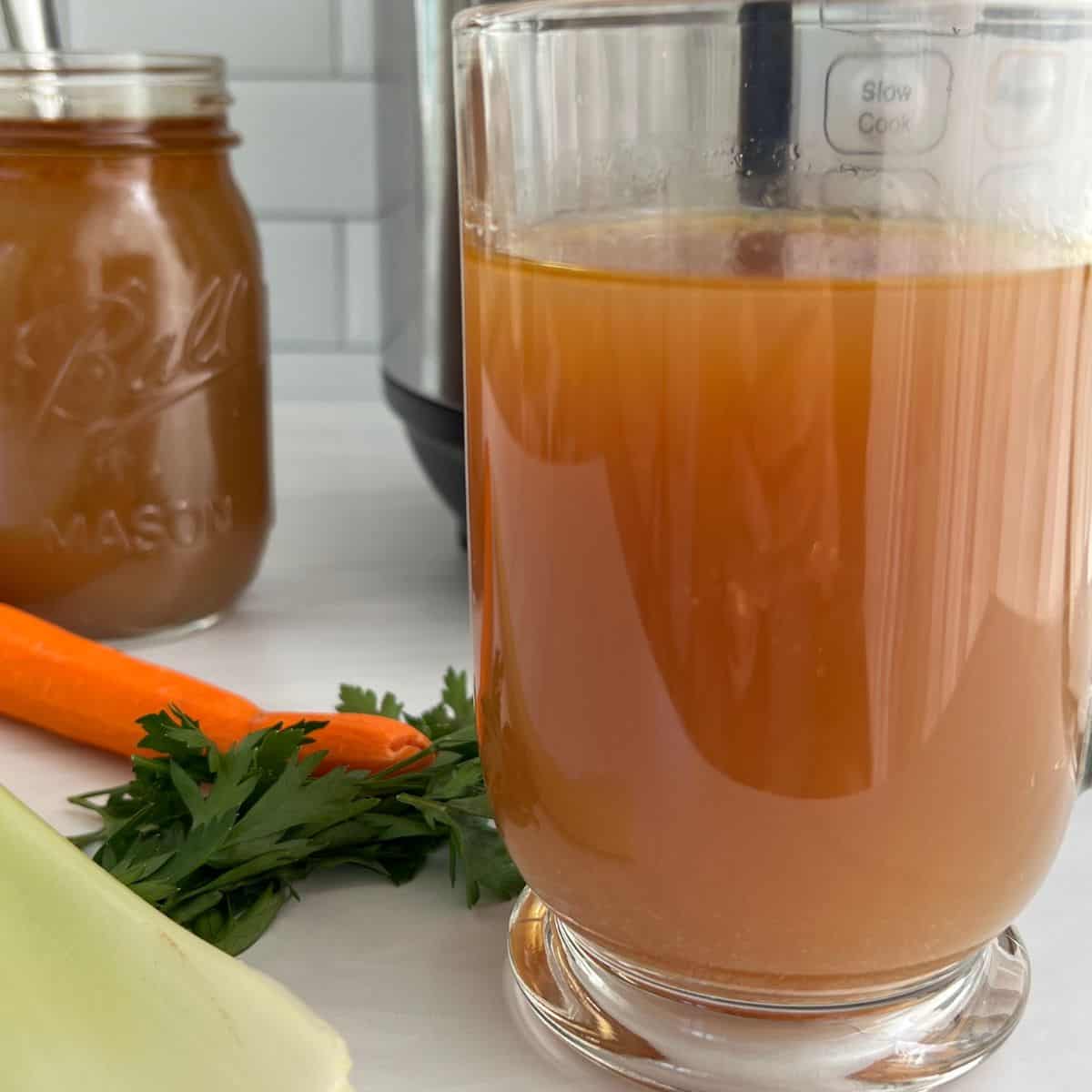 Bone broth in a glass mug.