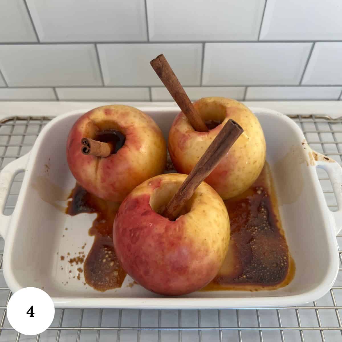 baked brown sugar and cinnamon apples in a white baking dish.