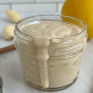 Lemon Garlic Tahini Sauce in a jar. Featured Image