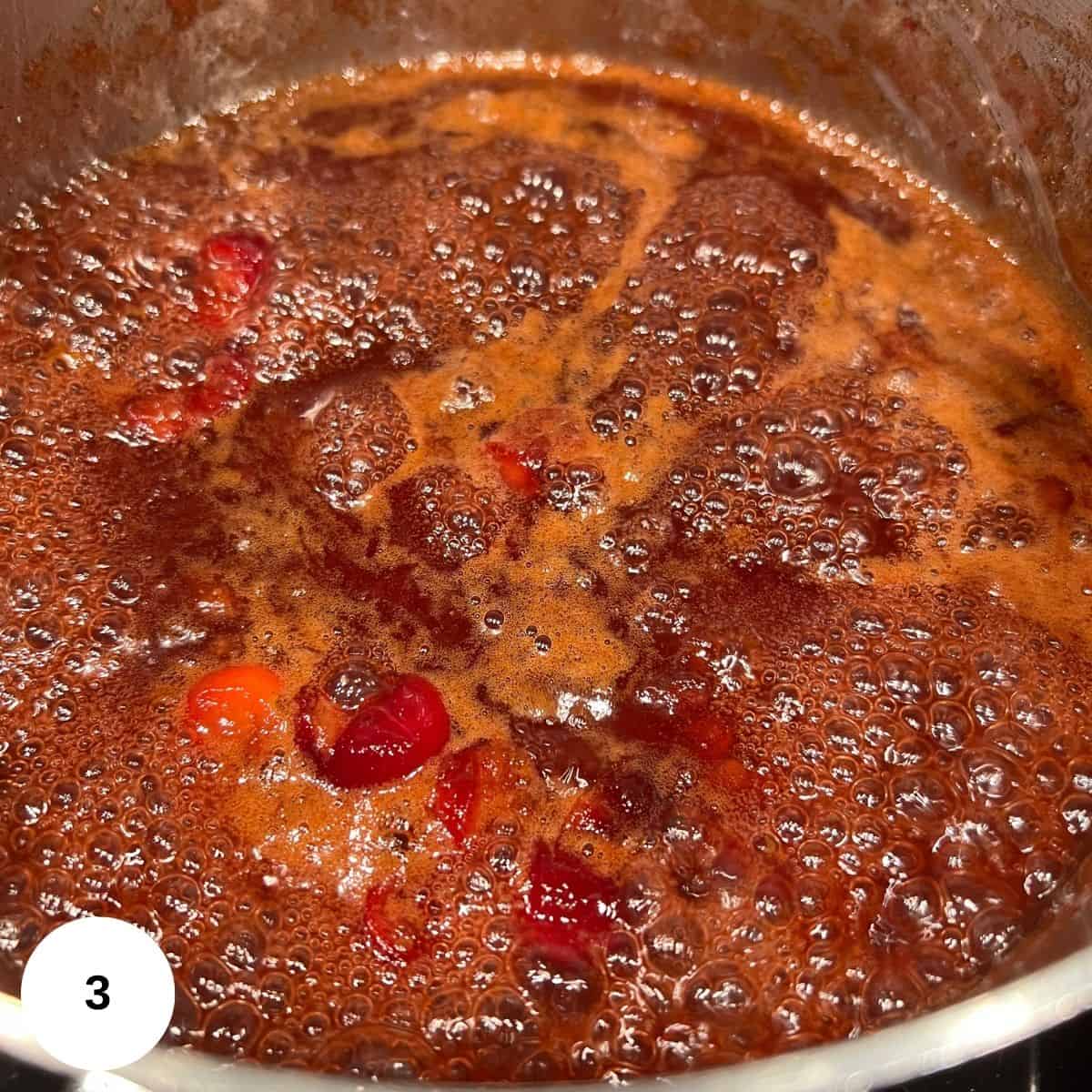 Sauce simmering in a pot on the stove. 