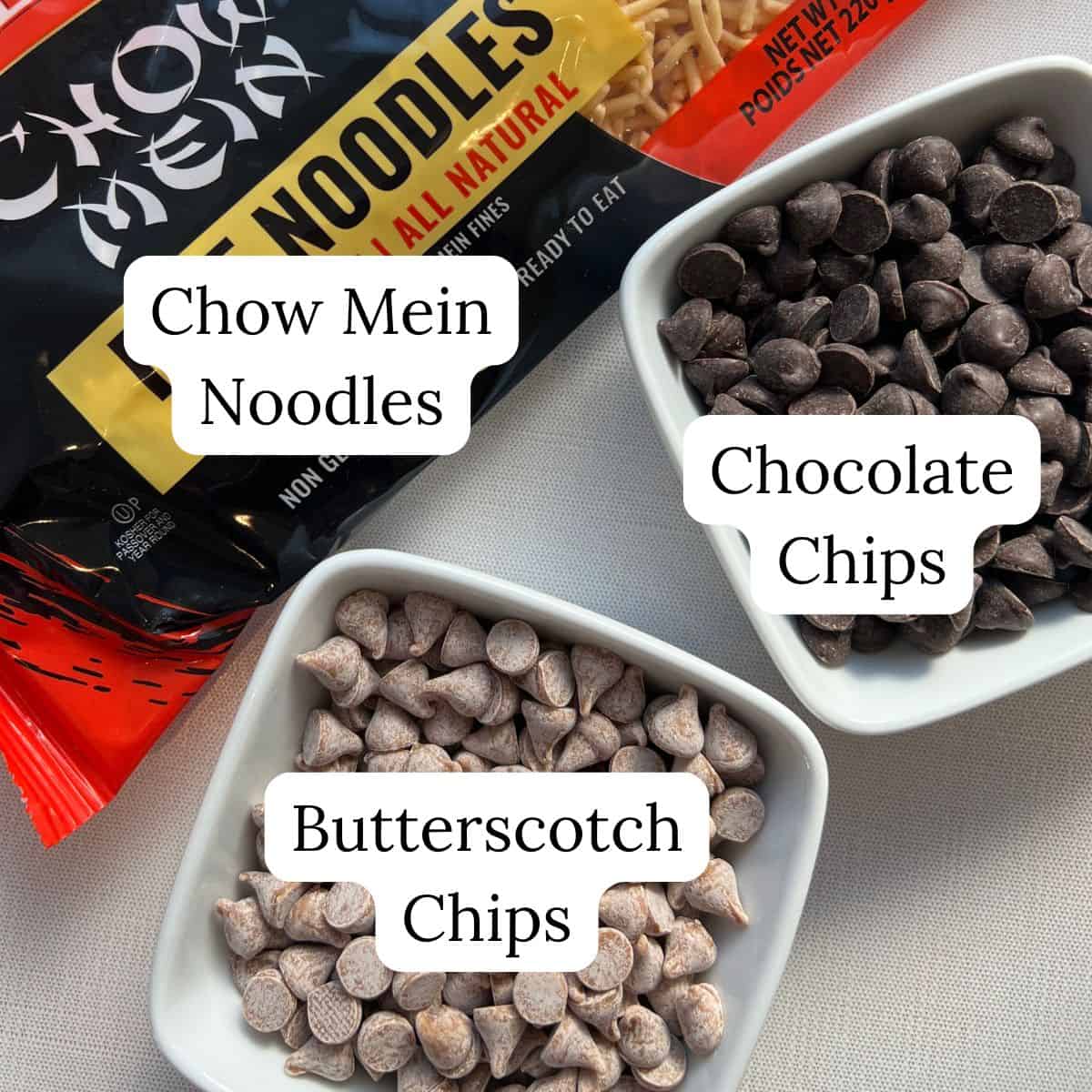 A bag of chow mein noodles and two small bowls, one filled with chocolate chips and the other with butterscotch chips, each labeled accordingly-perfect ingredients for making classic Haystacks Candy.