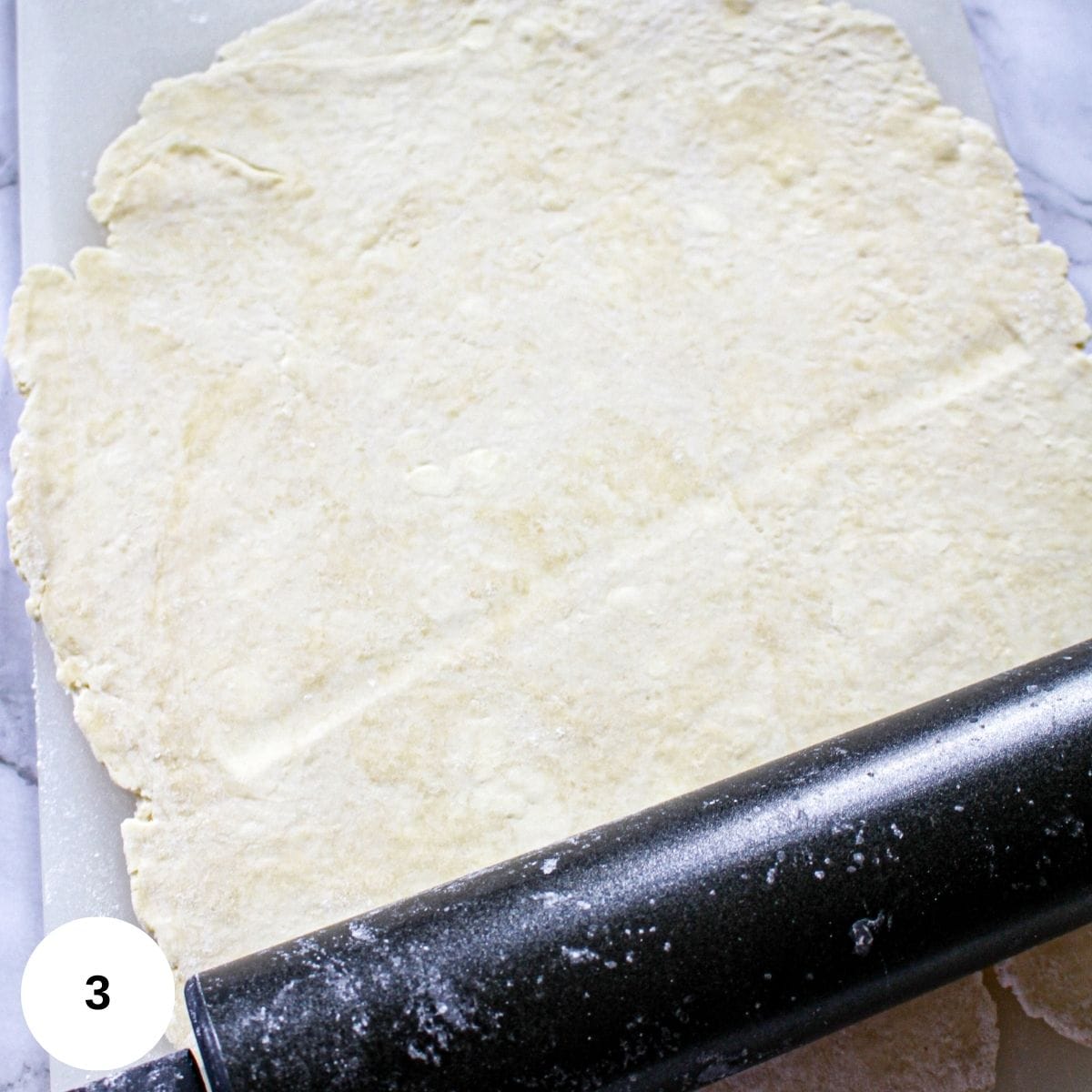 rolling the dough out to fit the pan.