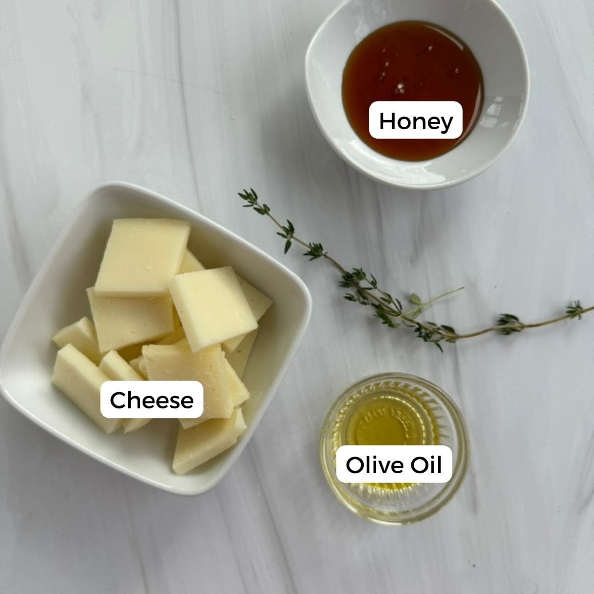 ingredients for Portuguese Creamy Baked Cheese with Honey and Olive Oil are cheese, honey, and olive oil.