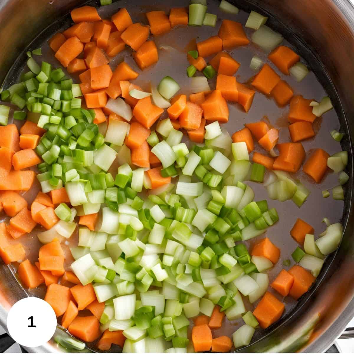 Simmering carrots, celery, and onion in a stockpot. 