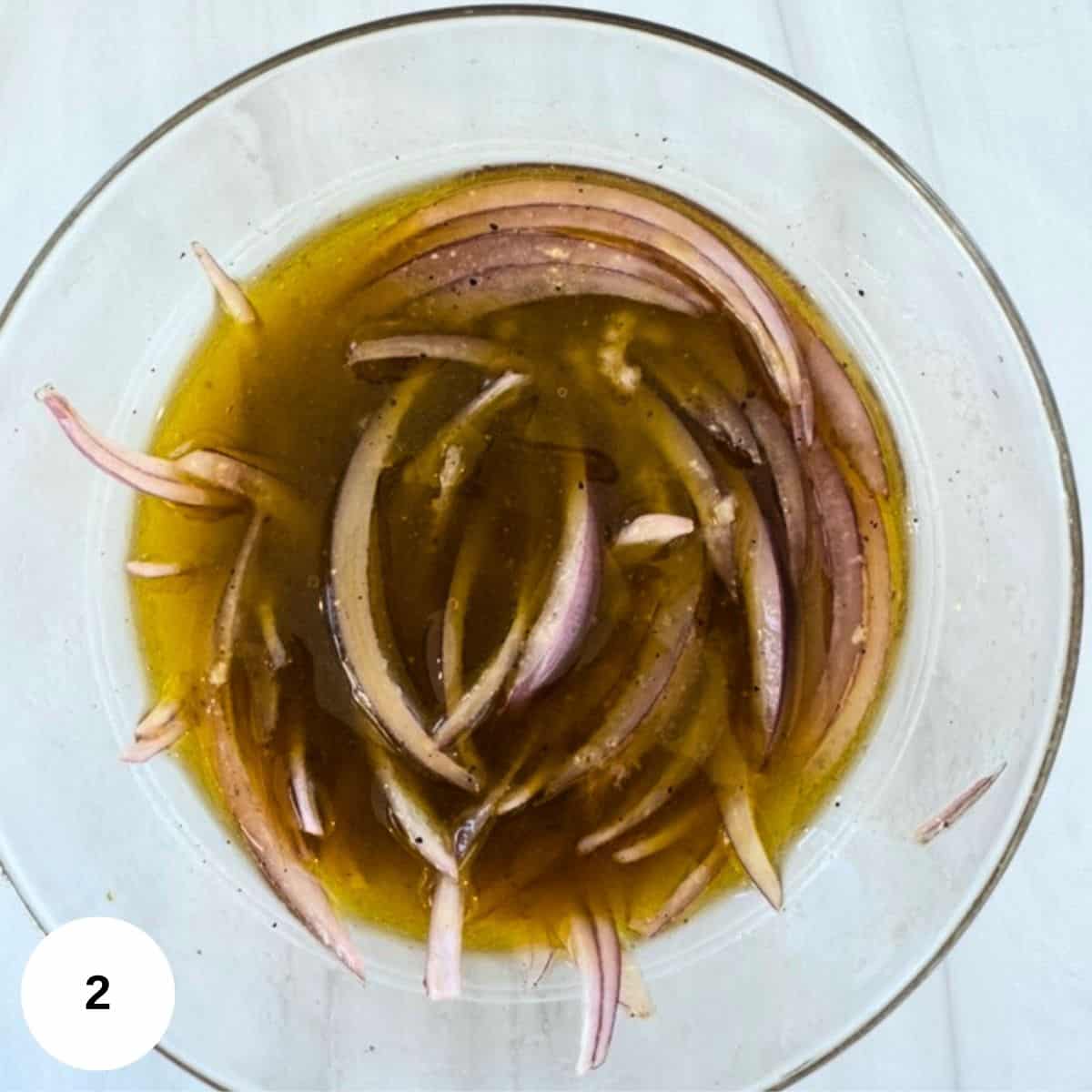 Adding the onions and garlic to the marinade. 