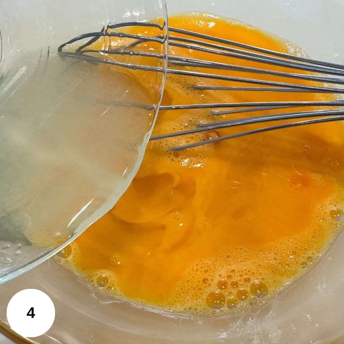 Whisking the eggs with the lemon juice before tempering with the chicken stock. 