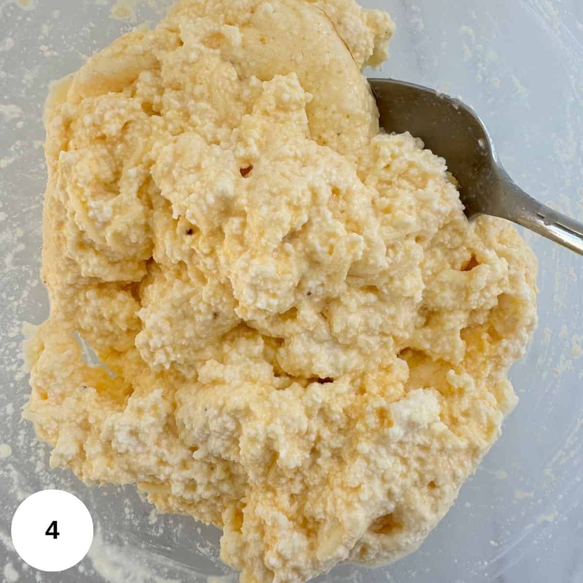 Prepared ricotta topping in a clear bowl. 