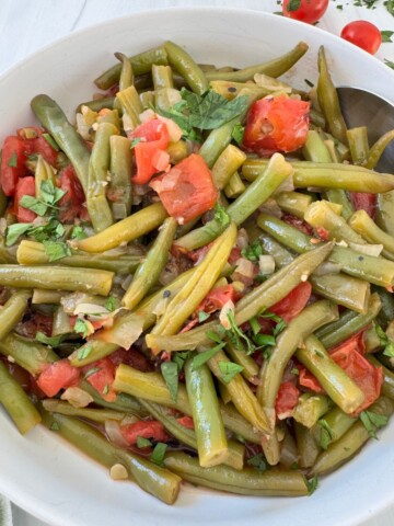 Greek Green Beans Recipe in a white bowl.