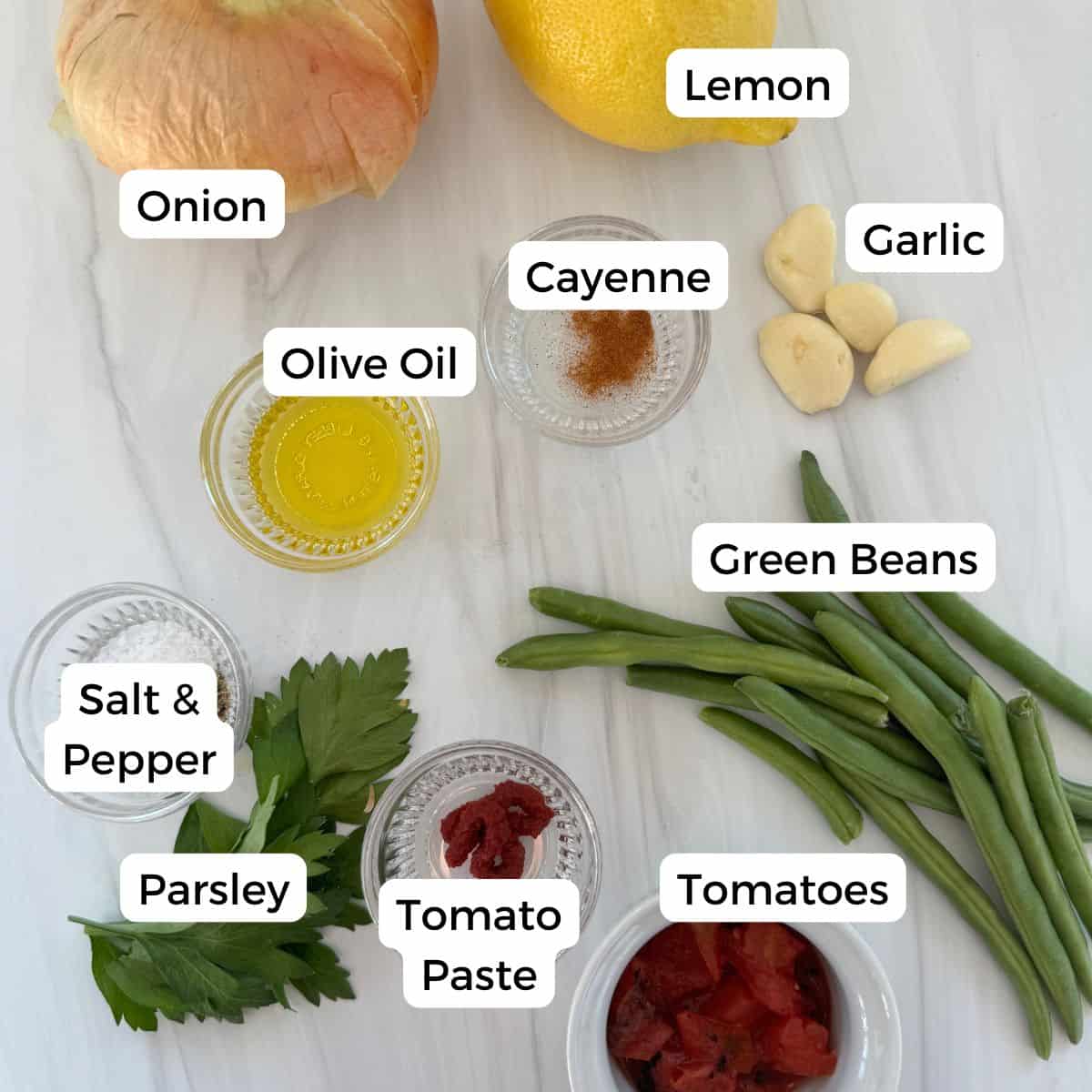 Ingredients include onion, lemon, olive oil, cayenne, garlic, green beans, tomatoes, tomato paste, parlsey, salt & pepper. 