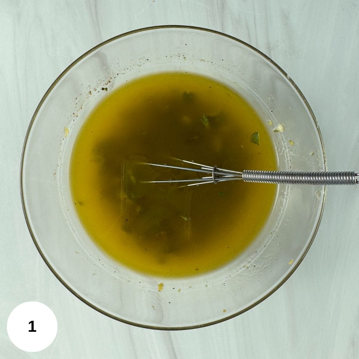 All of the marinade ingredients combined in a glass bowl. 