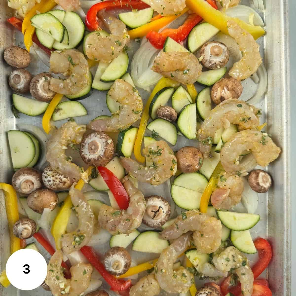 Layng the shrimp and vegetables out on a prepared sheet pan. 