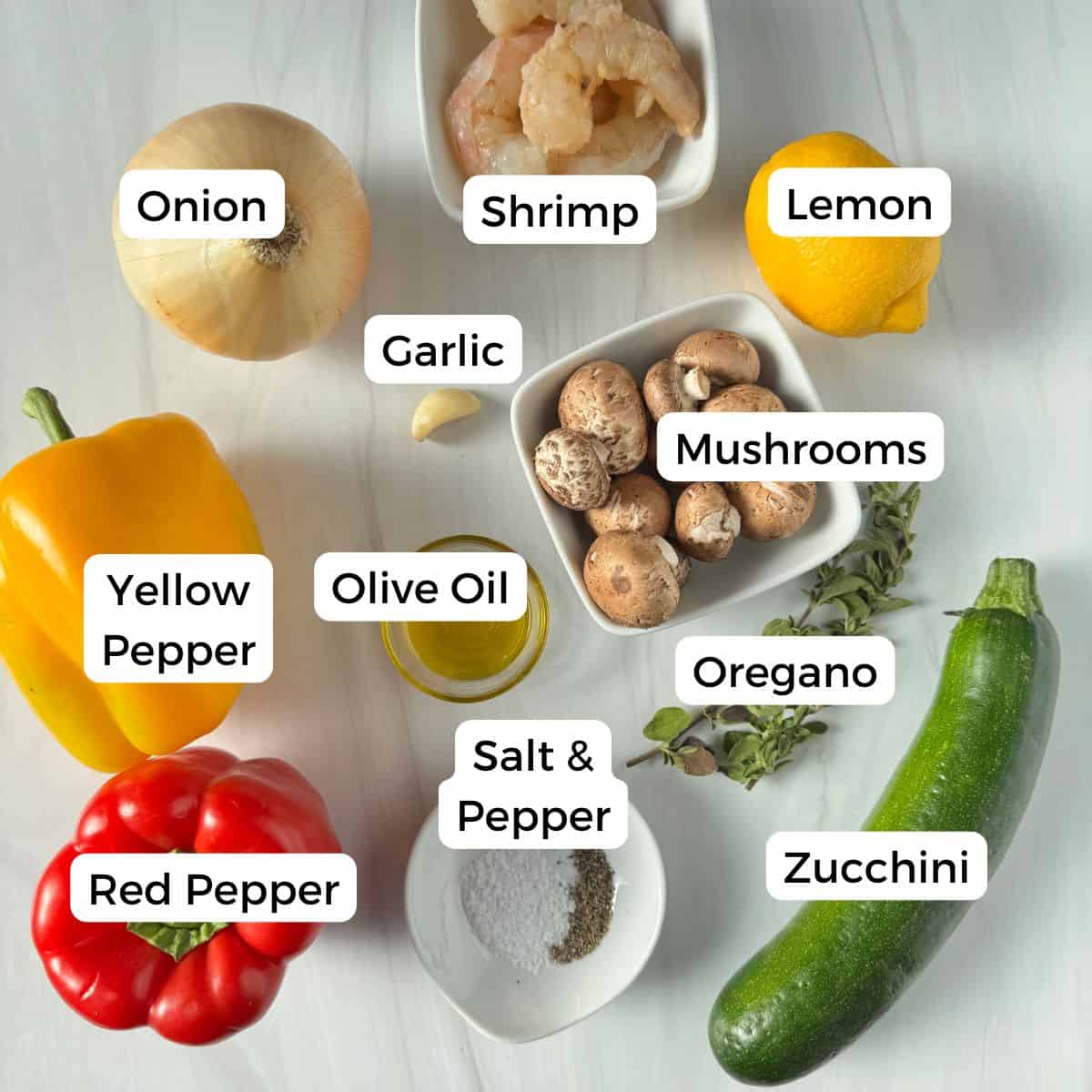 Ingredients include shrimp, lemon, garlic, onion, peppers, olive oil, mushrooms, oregano, zucchini, salt and pepper. 
