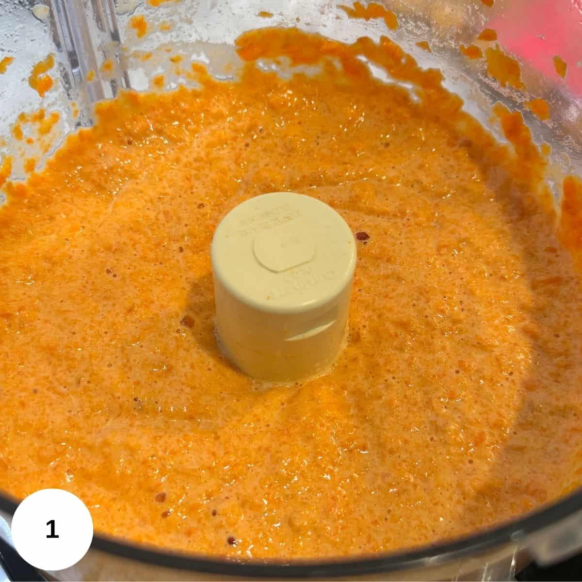 Pureeing the carrots in a food processor along with eggs.
