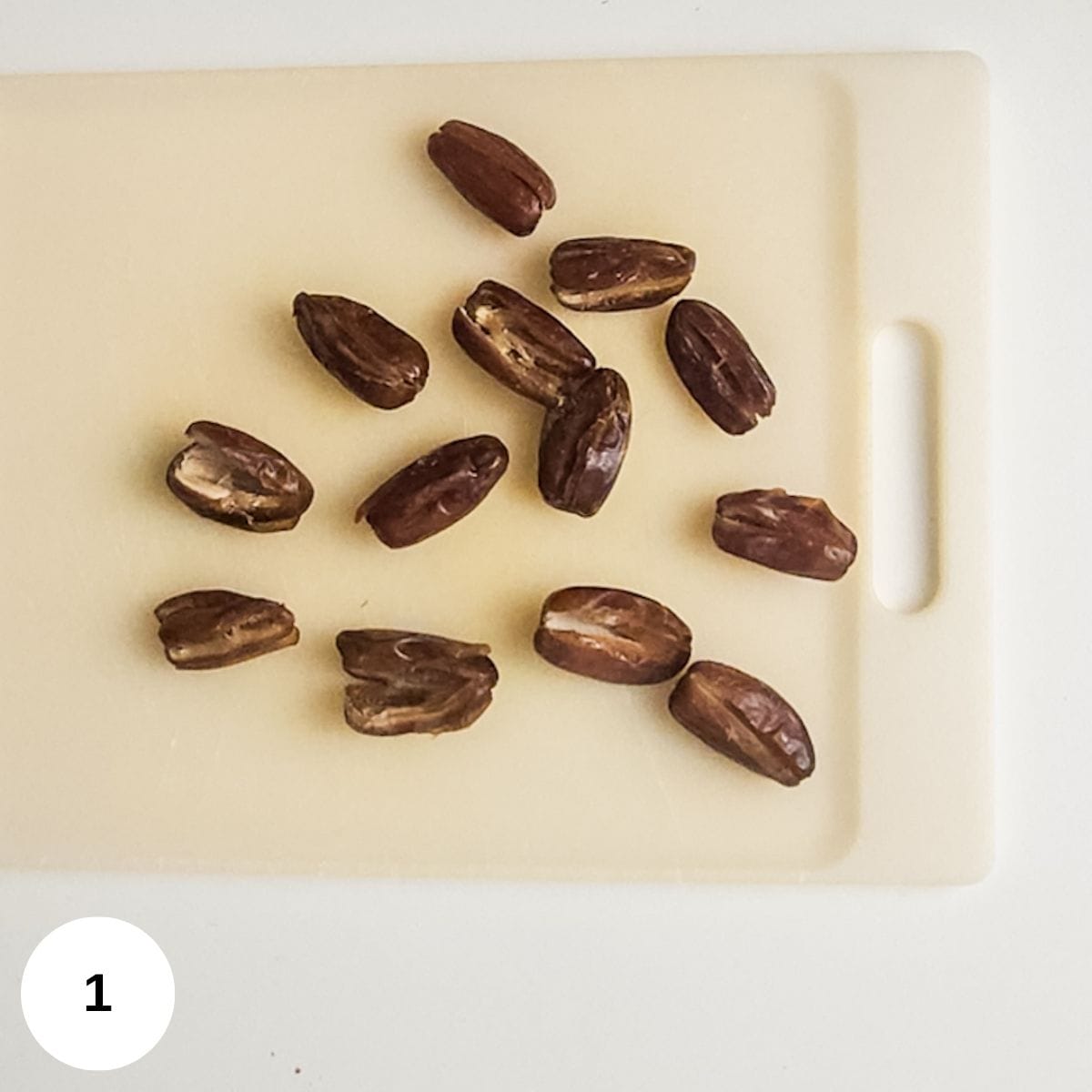 Slicing open the dates and taking out the pits. 