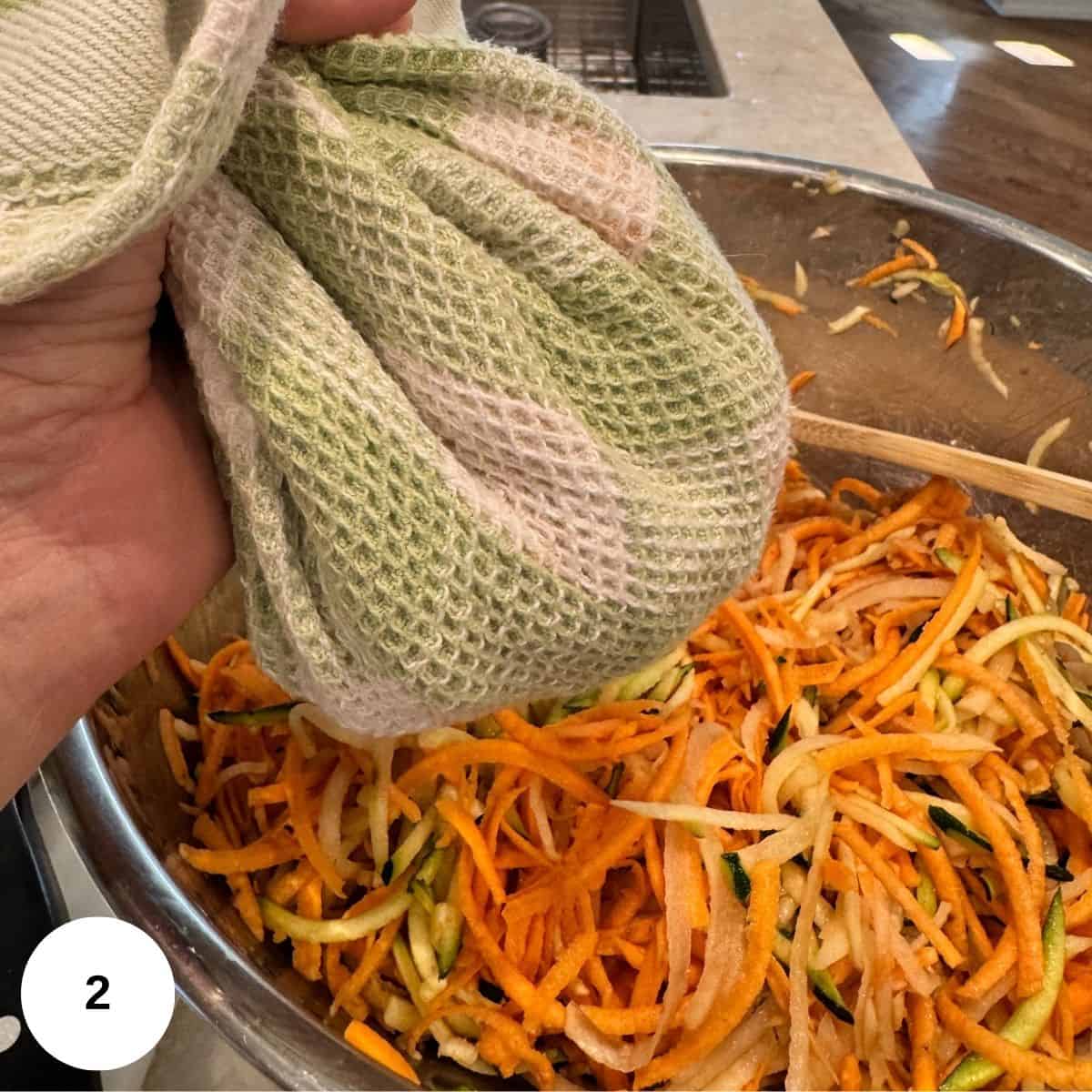 Using a kitchen towel to wring out all of the liquid. 