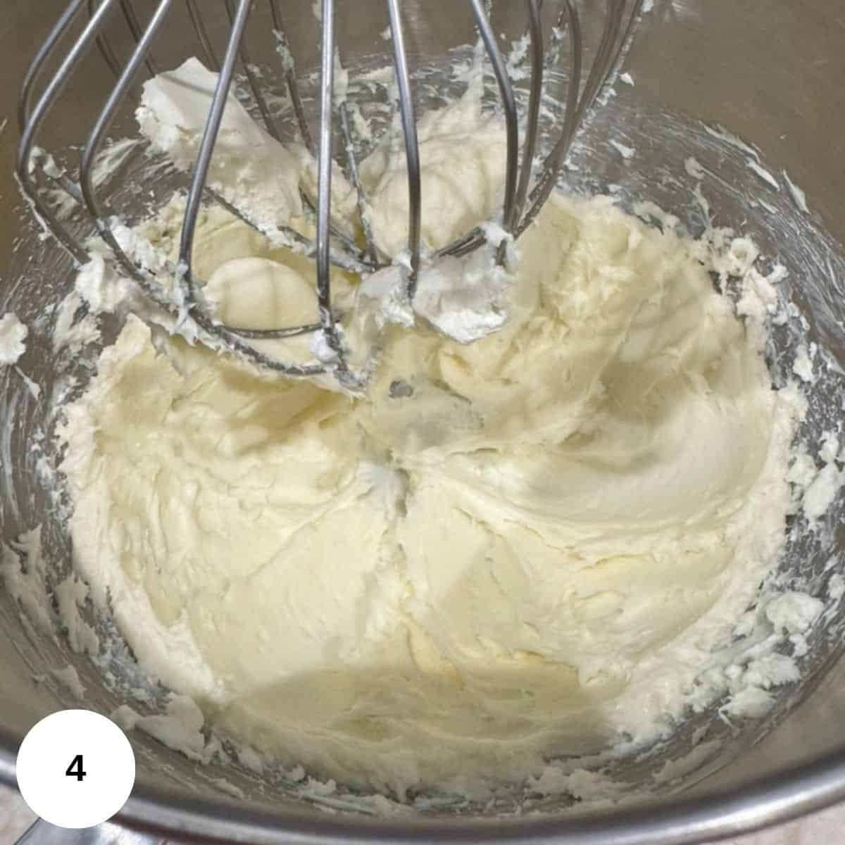 All of the topping being whipped in an electric mixer.