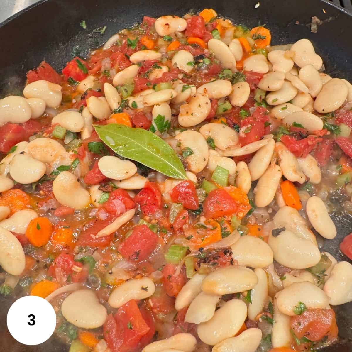 Adding the beans and cooking more. 