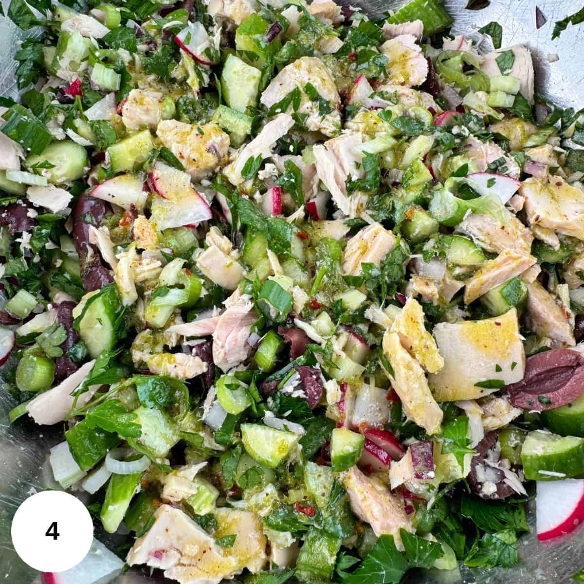 Adding in the dressing and mixing all of the ingredients together. 