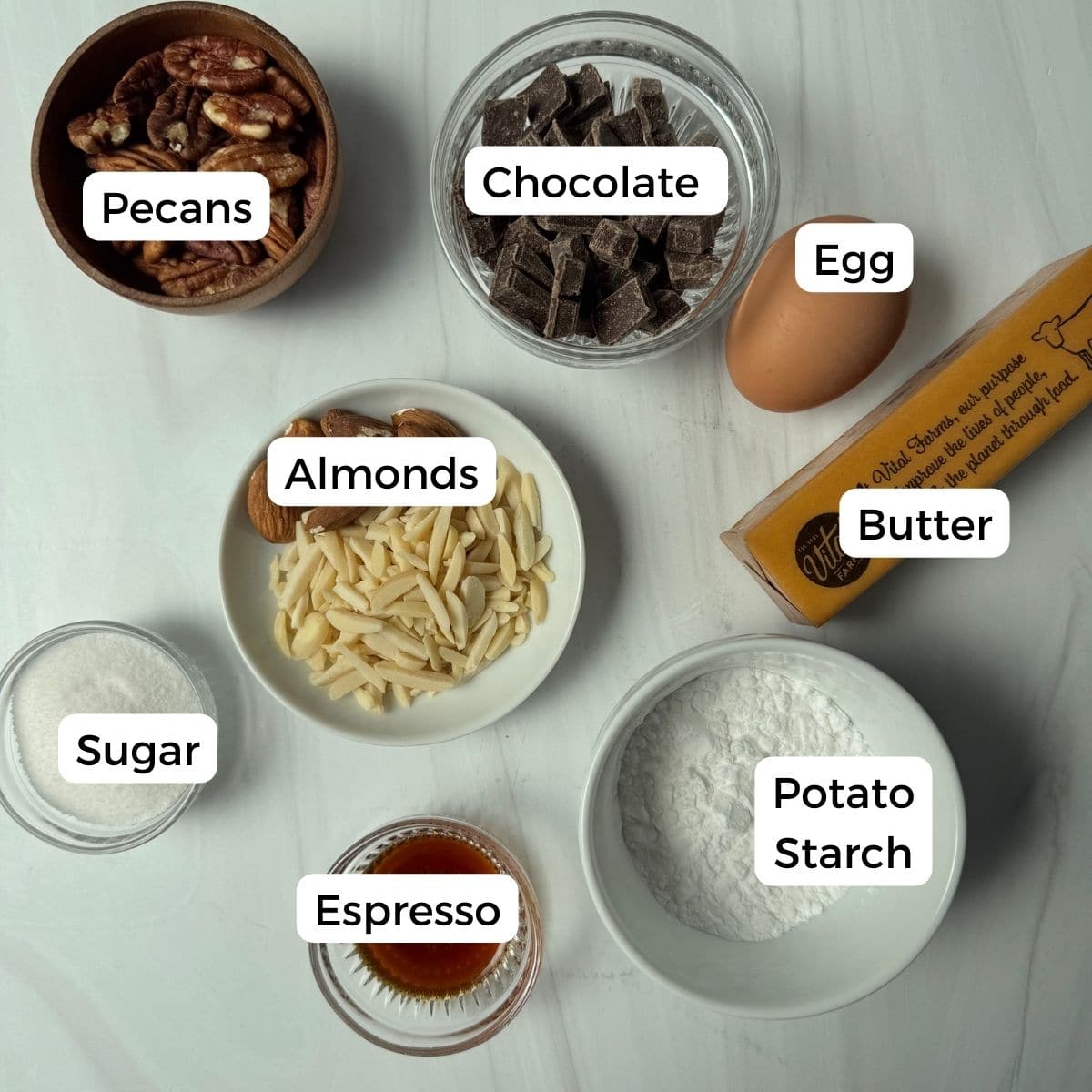 Ingredients include pecans, chocolate, eggs, butter, almonds, potato starch, espresso, and sugar. 