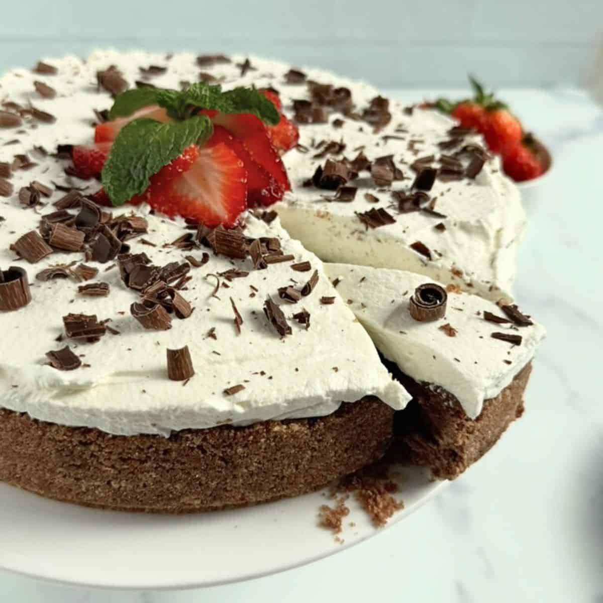 Chocolate Mousse Cheesecake with a slice partially coming off the cake.