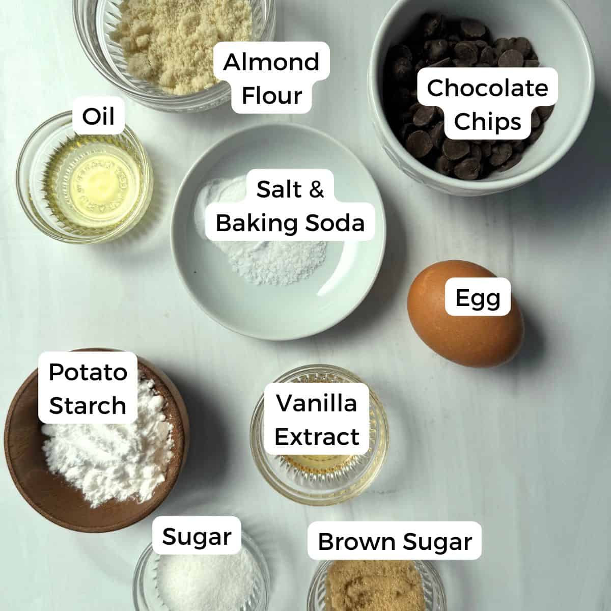 Ingredients include almond flour, chocolate chips, oil, slat, baking soda, egg, potato starch, vanilla, sugar and brown sugar. 