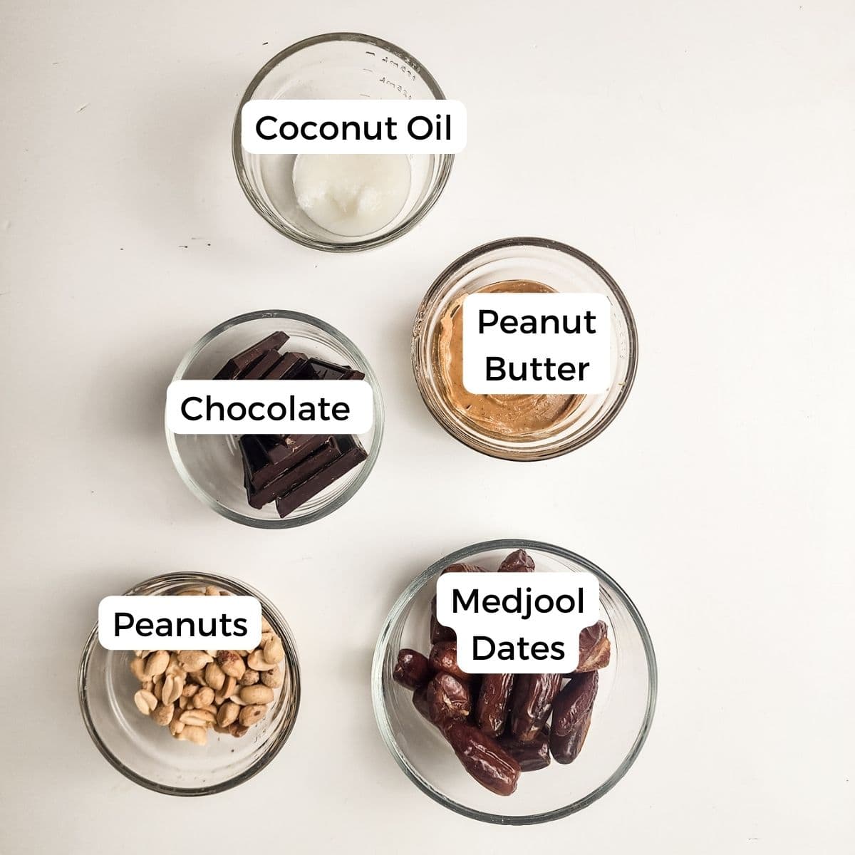 Ingredients include dates, peanuts, peanut butter, chocolate, and coconut oil. 